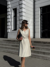 A woman wears a worsted wool dress